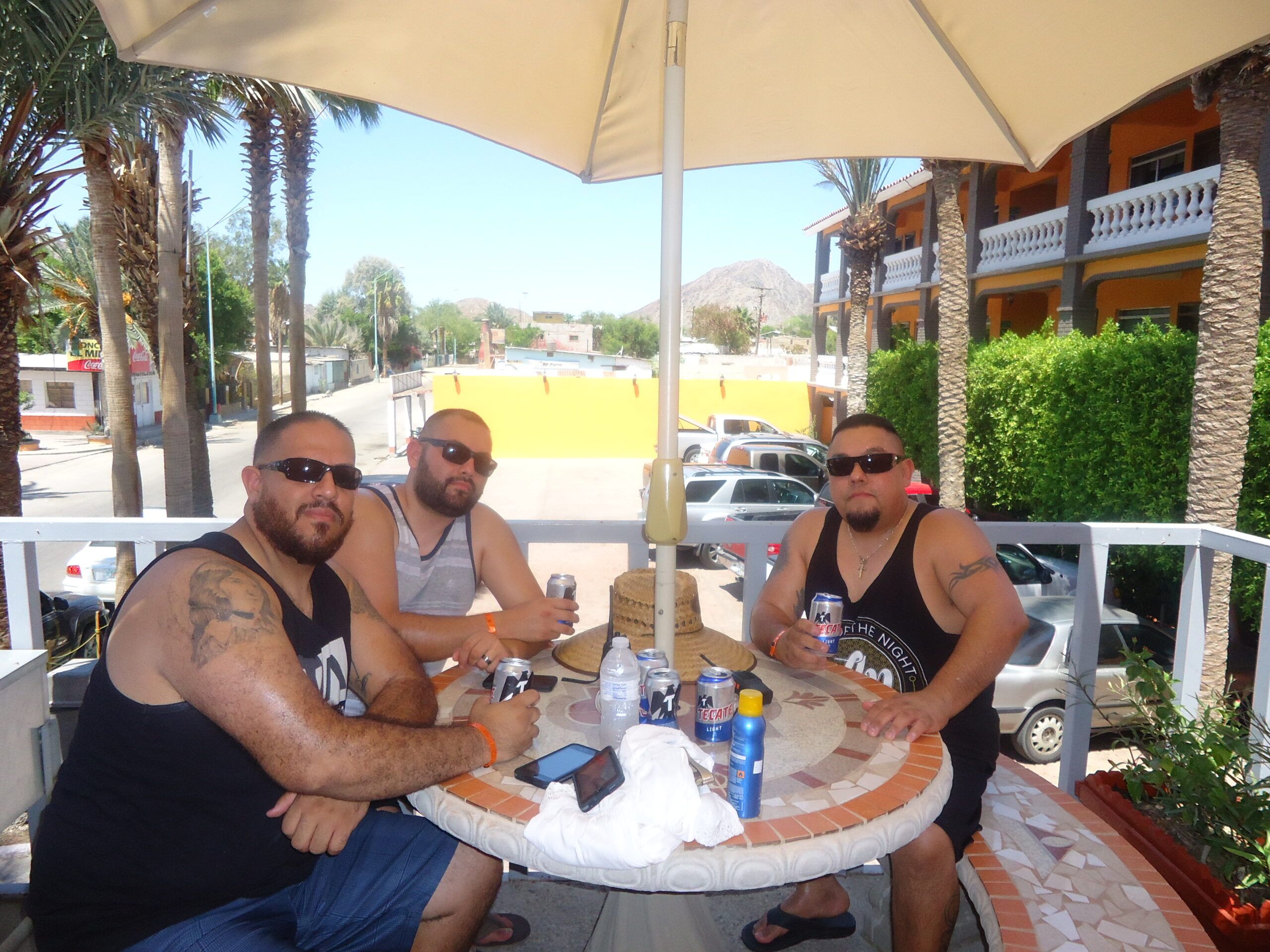 Guests relaxing at a shaded table on the terrace