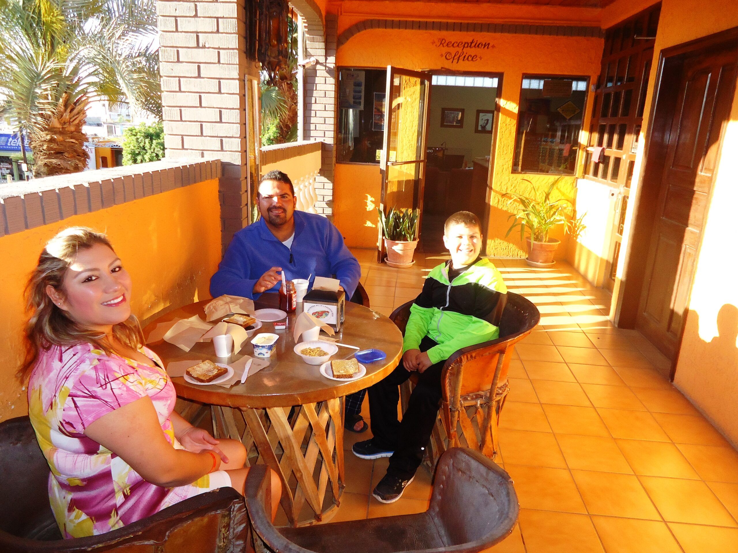 Family having breakfast outside the reception office